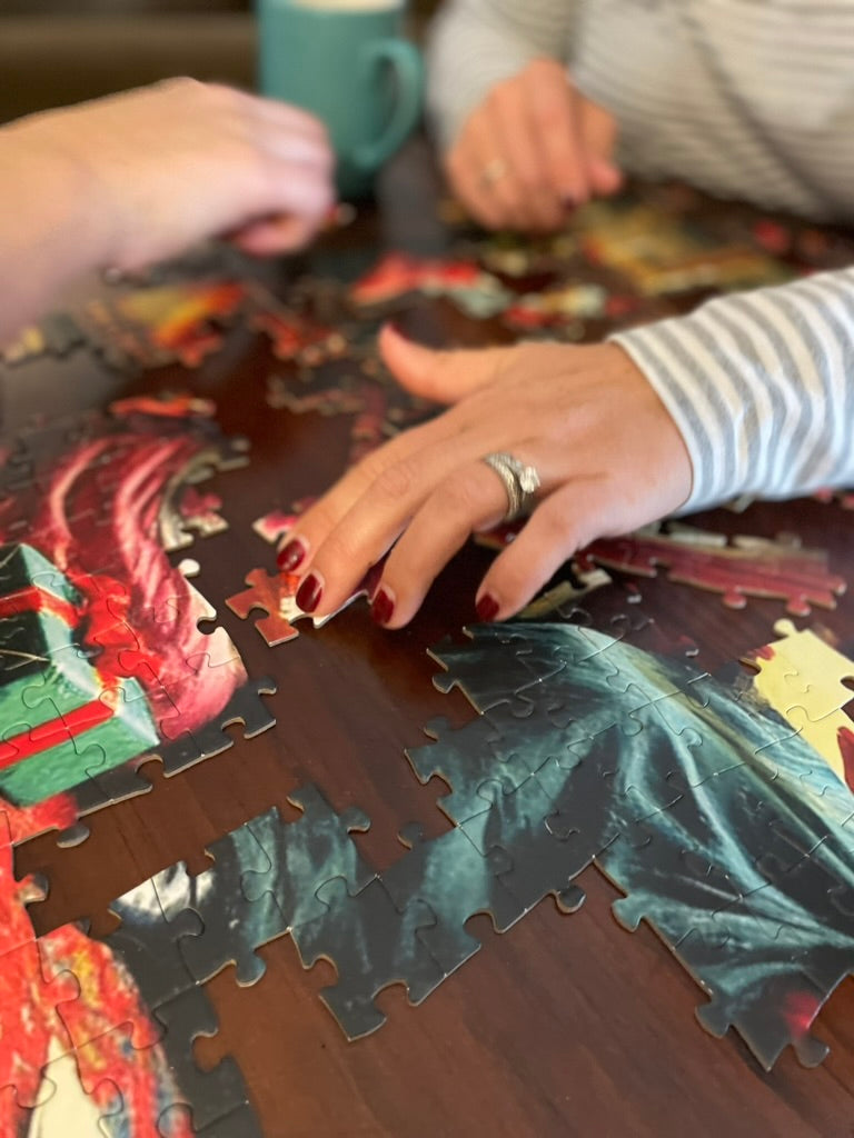 Book Club Friends Enjoy Coffee and Conversation While Piecing Together Little Women Puzzle